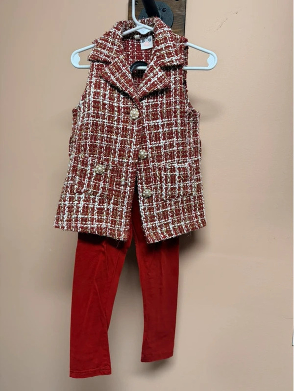 This child's clothing set features a red and white checkered tweed vest.
